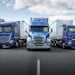 Blue Mercedes-Benz, Freightliner and Fuso trucks on a test track